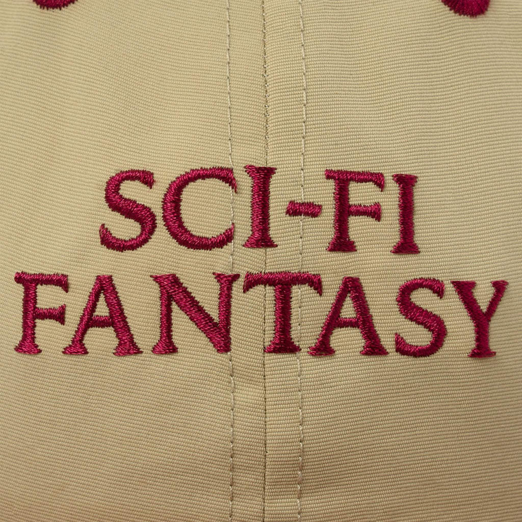 A close up of the dark red embroidered sci-fi logo on ht efornt of the hat.