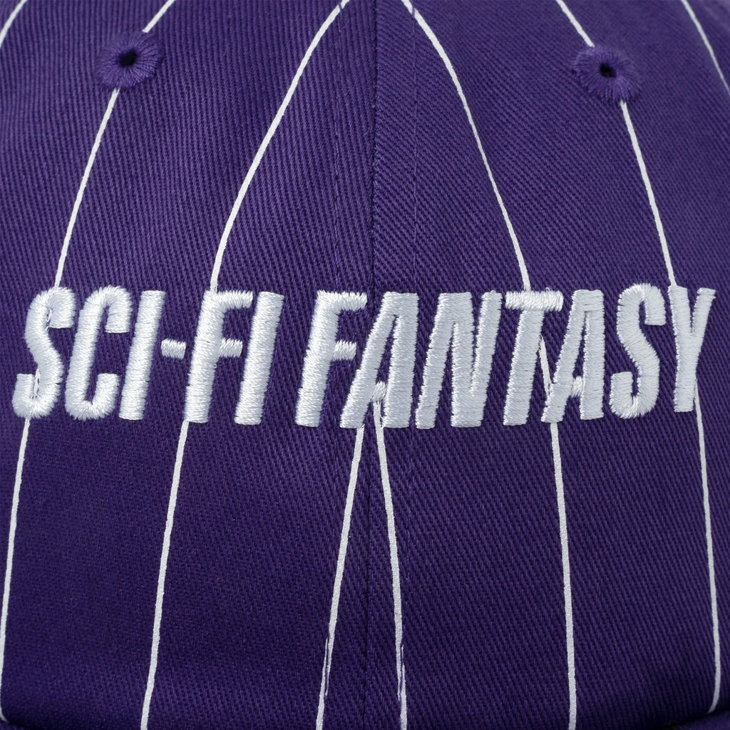 A close up of the white sci-fi logo embroidered on the front of the hat.