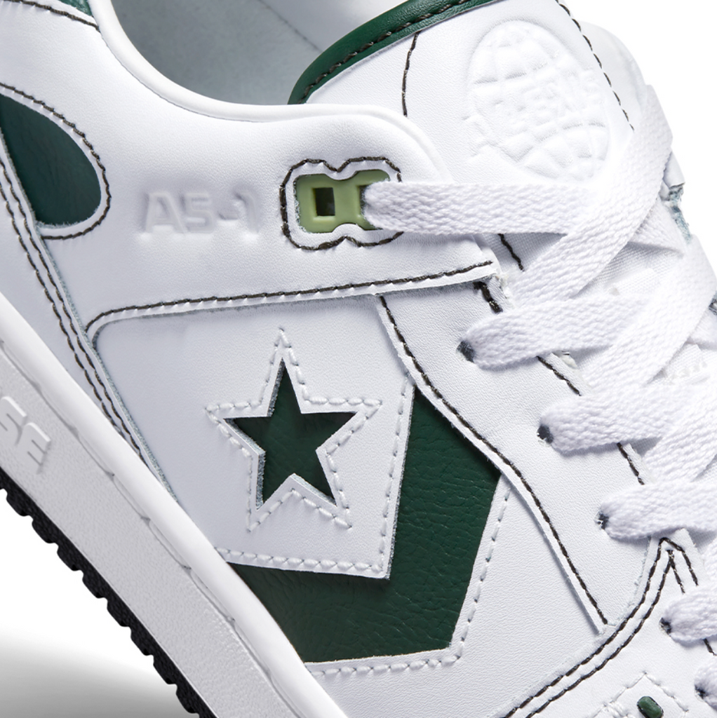 A CONVERSE CONS ALEXIS AS-1 PRO WHITE / GREEN with a star on the side.
