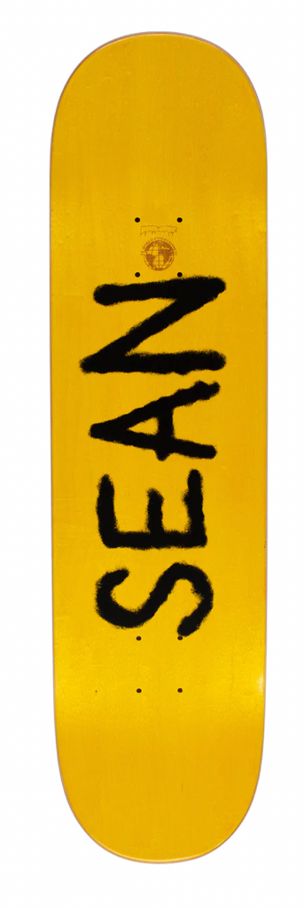 "Sean" signature text on top of stained skateboard top