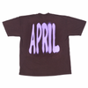 big purple spray paint style letters spell out april on the back of this brown shirt