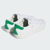 A picture showing the green suede heel tabs/caps on the pair of white shoes.