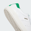 A close of of the adidas logo molded into the heel of a white leather shoe.