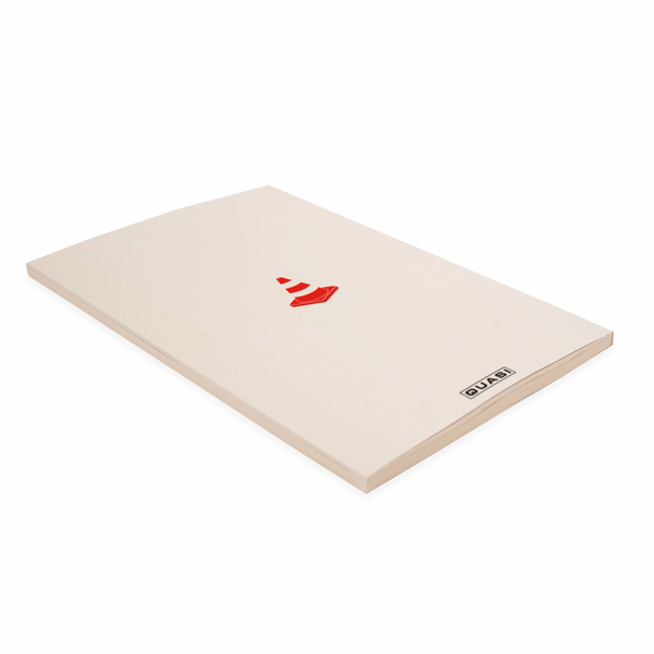 A white QUASI notebook with a red logo on it, perfect as a companion for note-taking or bookmarking during simulations.