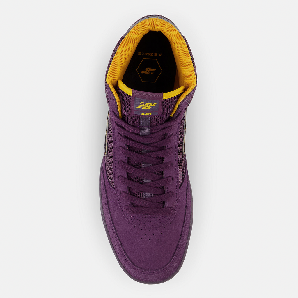 The top view of a purple shoe with yellow accents that shows the ABSORB insole.