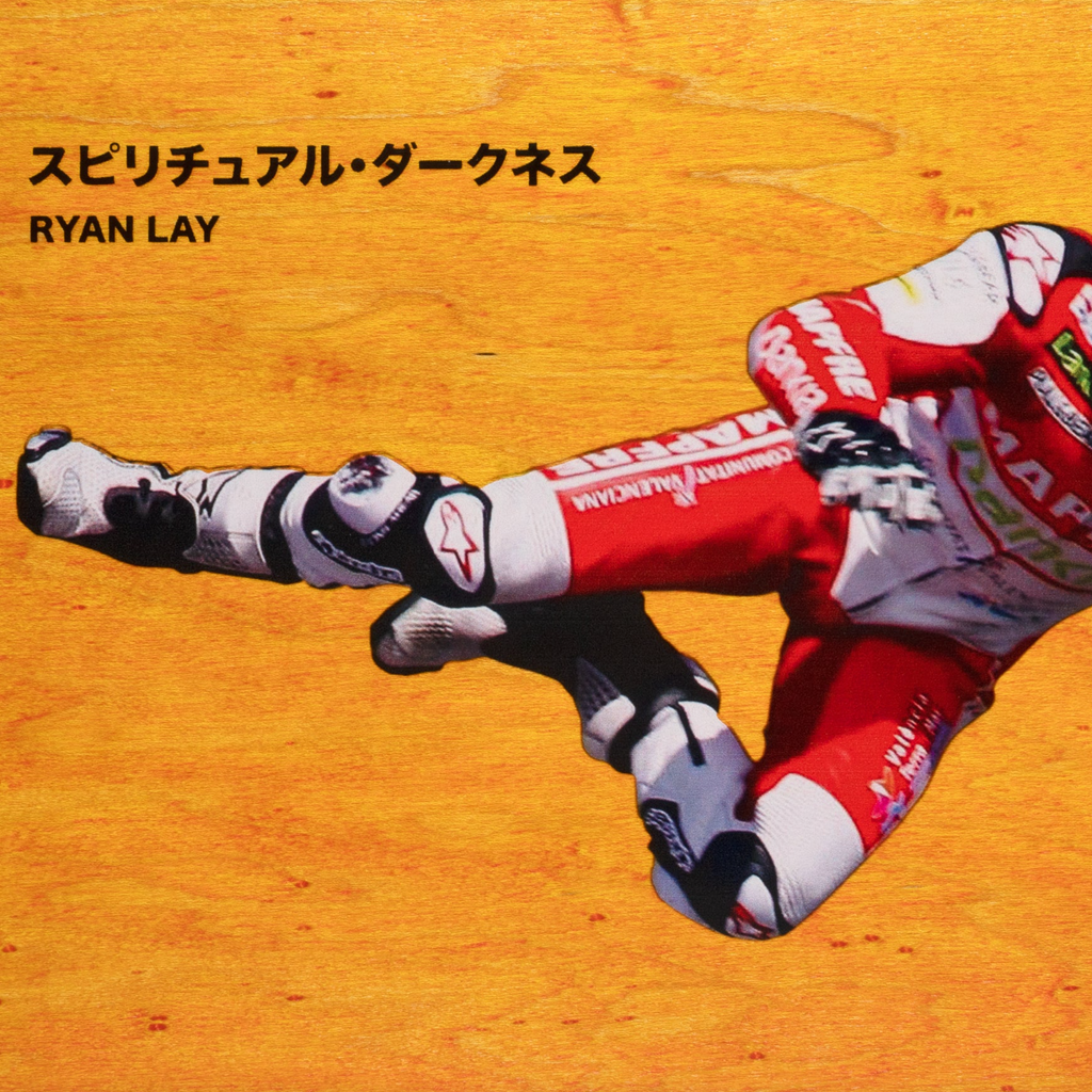 A close up of the image of the driver falling with japanese text and the name "Ryan Lay".
