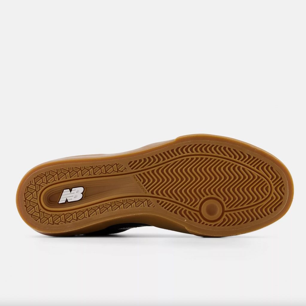 The sole of a NB NUMERIC 272 BLACK / WHITE shoe with a brown sole.