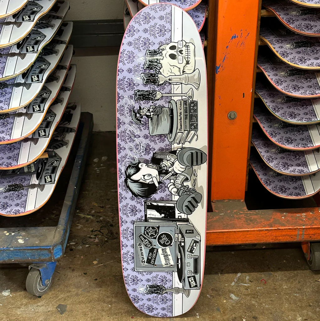 A STRANGELOVE GOTH PUPPET skateboard with glow in the dark artwork by Sean Cliver, inside a warehouse.