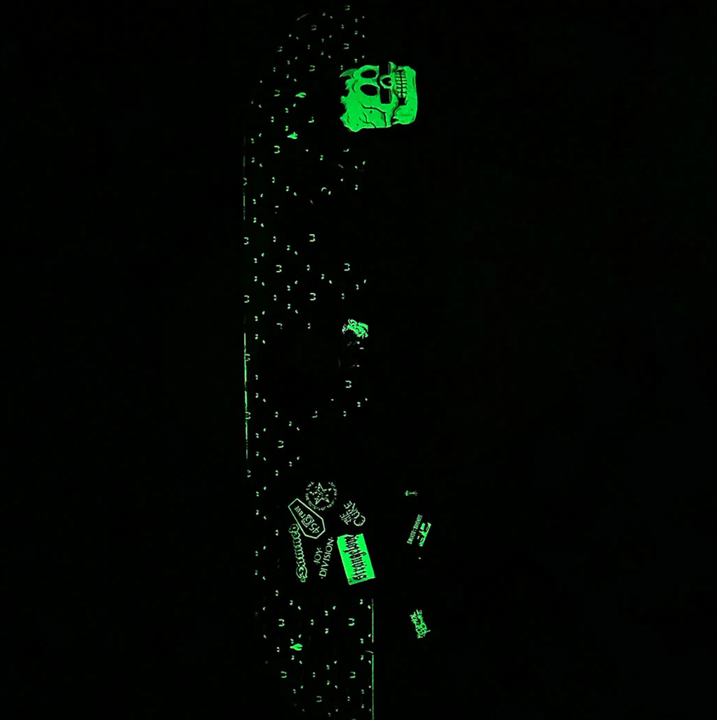 A Strangelove skateboard with a green glow in the dark, artwork by Sean Cliver.