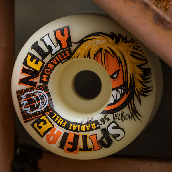 A close-up of a SPITFIRE F4 MORVILLE RADIAL FULL 99D 56MM skateboard wheel, displaying bold branding and an illustrated angry face, highlights these premium SPITFIRE skateboarding wheels.