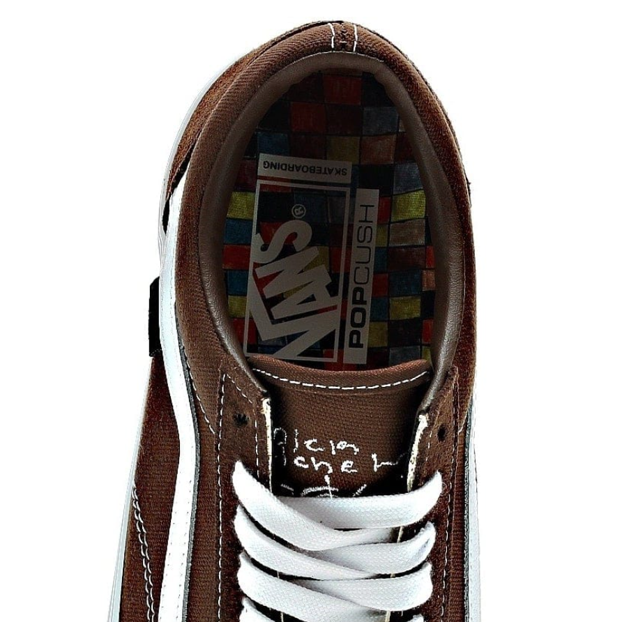 A top view of a dark brown shoe with white accents that shows the "pop cush" insole.