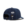 The Butter Goods BUTTER X PEANUTS SPIKE 5 PANEL CAP NAVY / LIGHT BLUE is a navy cotton cap with blue stitching and an embroidered Snoopy “Sigh” detail above the adjustable strap.