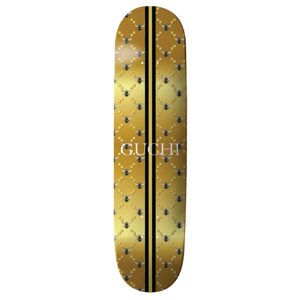 A THANK YOU 'GUCHI' BEE GOLD skateboard with the word cufi on it, designed by Danny Hamaguchi.