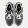 A pair of NB NUMERIC "GREY DAYS" REYNOLDS 933 sneakers in dark grey and white, viewed from above on a plain light background, showcasing heritage design and ABZORB midsole.