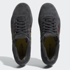 A pair of ADIDAS TYSHAWN CARBON / CORE BLACK / PRELOVED BROWN men's grey shoes with a red and yellow stripe.