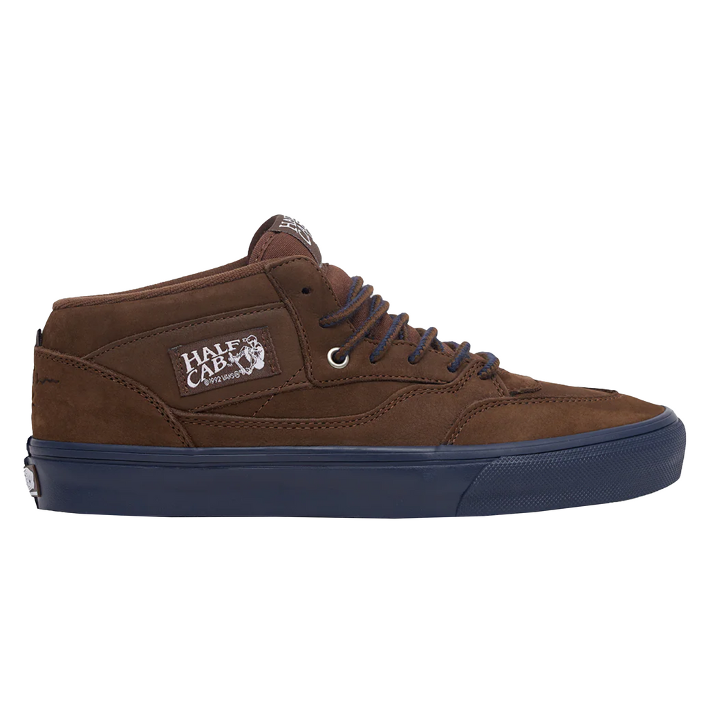 A brown bulkier shoe with a navy sole and brown/navy laces with the half cab label on the side.