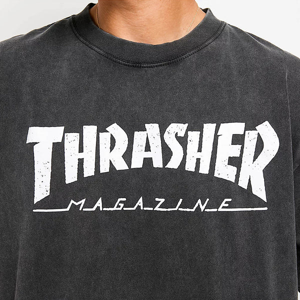 Close-up of a person wearing the THRASHER MAG LOGO VINTAGE TEE BLACK by THRASHER, featuring the iconic white Thrasher Mag Logo printed on the front.