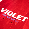 A close up of a red skateboard with the words "VIOLET KADER SYLLA" printed on it. The skateboard stain is red.