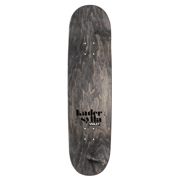 The VIOLET Skateboard deck, from the violet brand, features a captivating wood grain finish with "kader sylla VIOLET" prominently displayed in black and accented by a subtle blue metallic foil. This elegant design is further enhanced by a tranquil graphic of a girl in khumar playing basketball, making it truly exceptional.