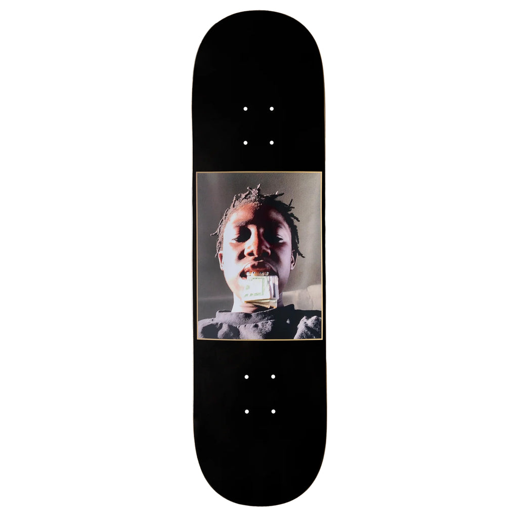 A black skateboard deck with an image of a man holding cash in his mouth.
