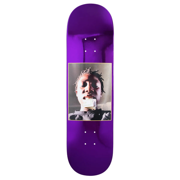 A metallic purple skateboard deck with an image of a man holding cash in his mouth.