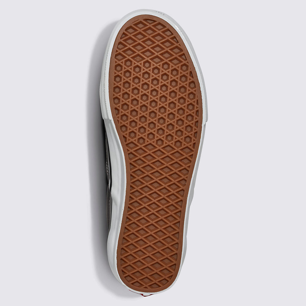 The sole of the VANS SKATE SLIP-ON SPORT BLUE/BLACK sneaker, showcasing a waffle-like tread pattern with DURACAP™ reinforcement and a tan color, is presented against a plain white background.