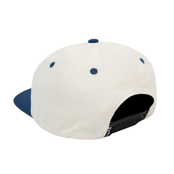 A WKND EVO FISH HAT NATURAL / NAVY on a white background made of Brushed Cotton.