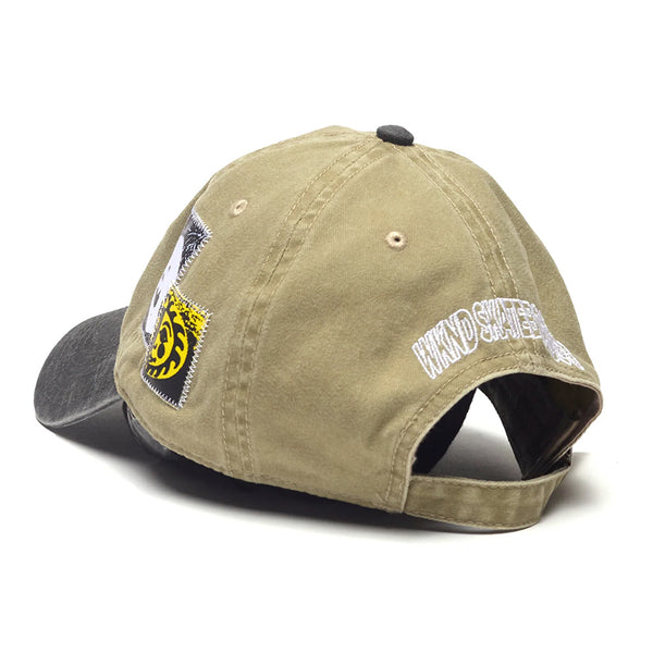 The WKND EDDY HAT KHAKI by WKND is a khaki and black embroidered hat with stylish patches, text details, and an adjustable back strap for a custom fit.