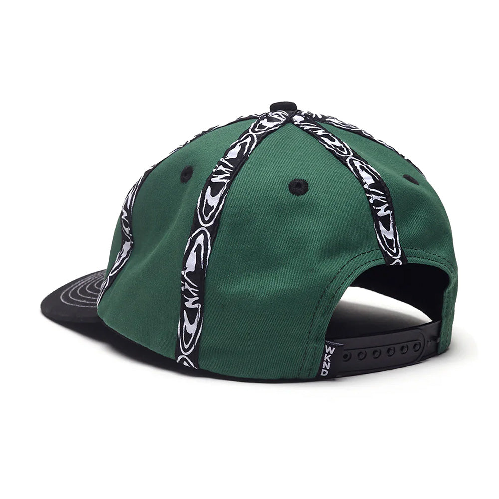 The WKND INSIDE OUT HAT GREEN by WKND is a green cotton hat with black and white striped patterns, a black brim, Fishbone woven tape accents, and is shown from the back.