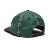The WKND INSIDE OUT HAT GREEN by WKND is a green cotton hat with black and white striped patterns, a black brim, Fishbone woven tape accents, and is shown from the back.