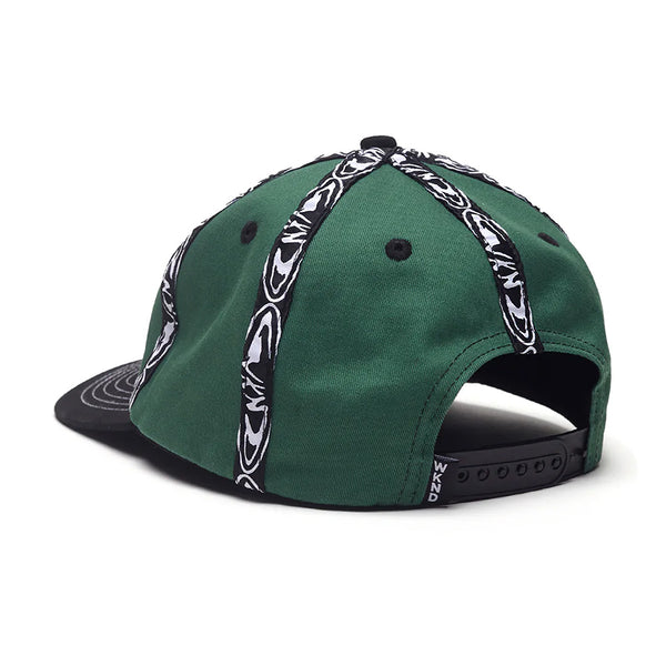 The WKND INSIDE OUT HAT GREEN by WKND is a green cotton hat with black and white striped patterns, a black brim, Fishbone woven tape accents, and is shown from the back.