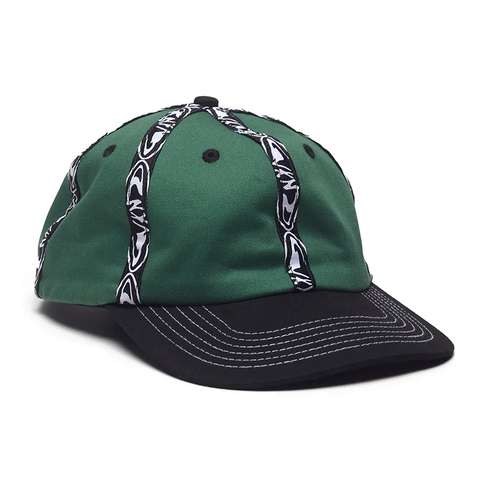 The WKND INSIDE OUT HAT GREEN by WKND is a green cotton hat with a black brim, white stitched details, and black and white fishbone woven tape stripes on the crown.