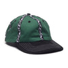 The WKND INSIDE OUT HAT GREEN by WKND is a green cotton hat with a black brim, white stitched details, and black and white fishbone woven tape stripes on the crown.