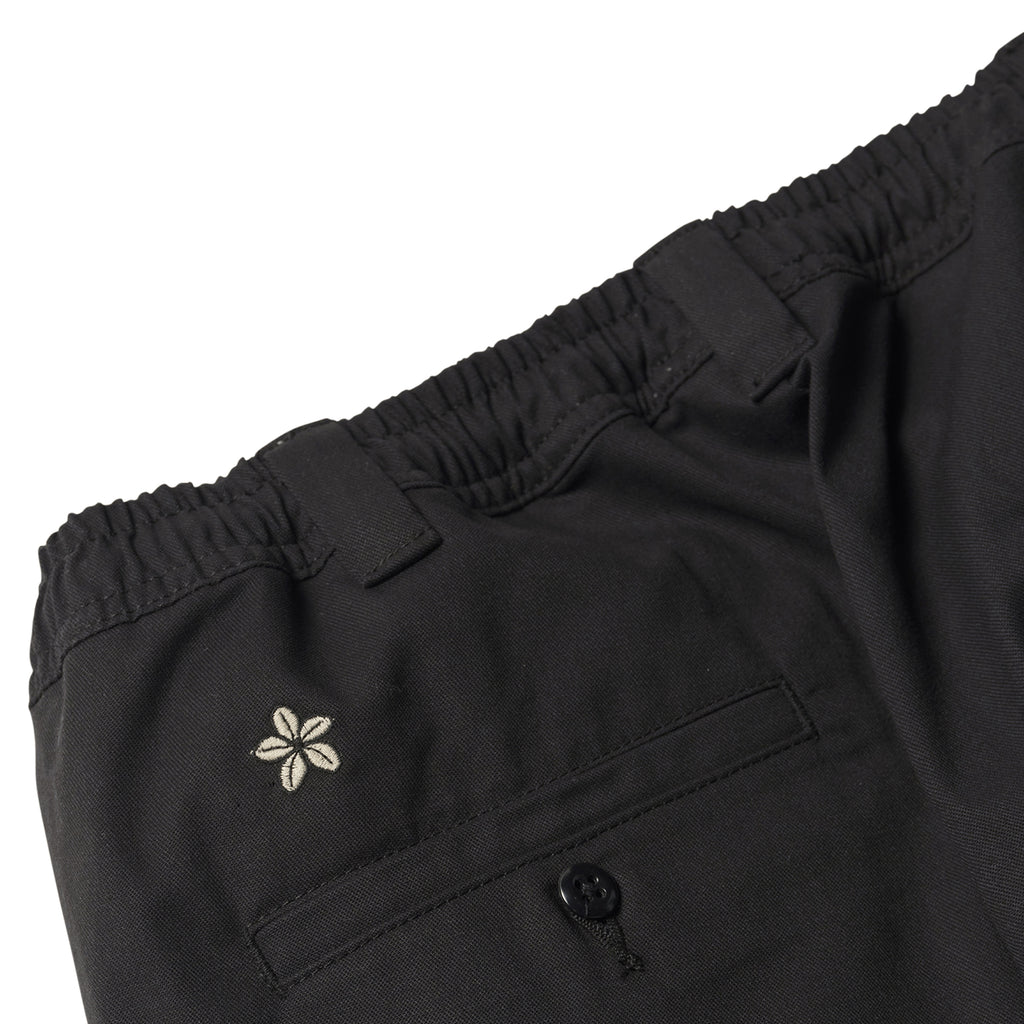 A pair of DICKIES TOM KNOX TWILL WORK PANT BLACK shorts with a flower on the pocket from DICKIES.