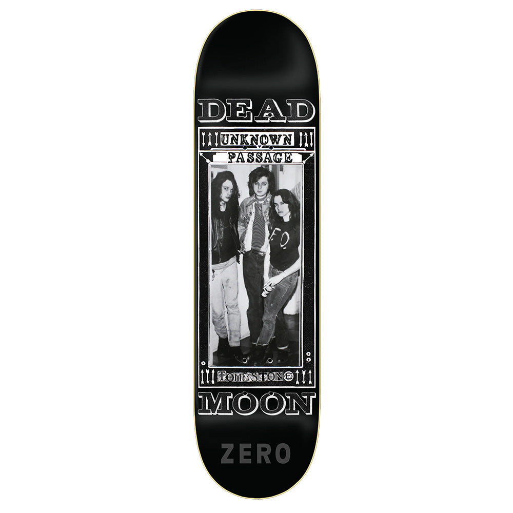 The ZERO X DEAD MOON UNKNOWN PASSAGE skateboard deck by ZERO features resin7 construction and a black-and-white photo of three people with the words "DEAD MOON" and "UNKNOWN PASSAGE.