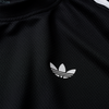 Close-up of an ADIDAS SKATEBOARDING BRASIL AEROREADY JERSEY BLACK featuring the white trefoil logo on the chest. The 100% cotton fabric has a textured, mesh-like pattern.