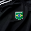 The ADIDAS SKATEBOARDING BRASIL AEROREADY JERSEY BLACK features a "Brasil" logo with the Brazilian flag emblem on the chest and is crafted from 100% cotton.