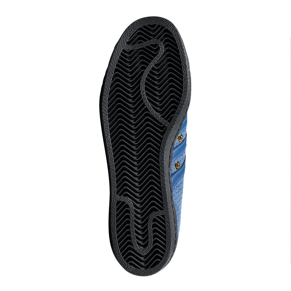 The underside of the ADIDAS X ARROW & BEAST SUPERSTAR ADV NIGHT MARINE / CORE BLACK skate shoe, with cupsole construction and a black zigzag-patterned rubber sole, is shown against a white background.
