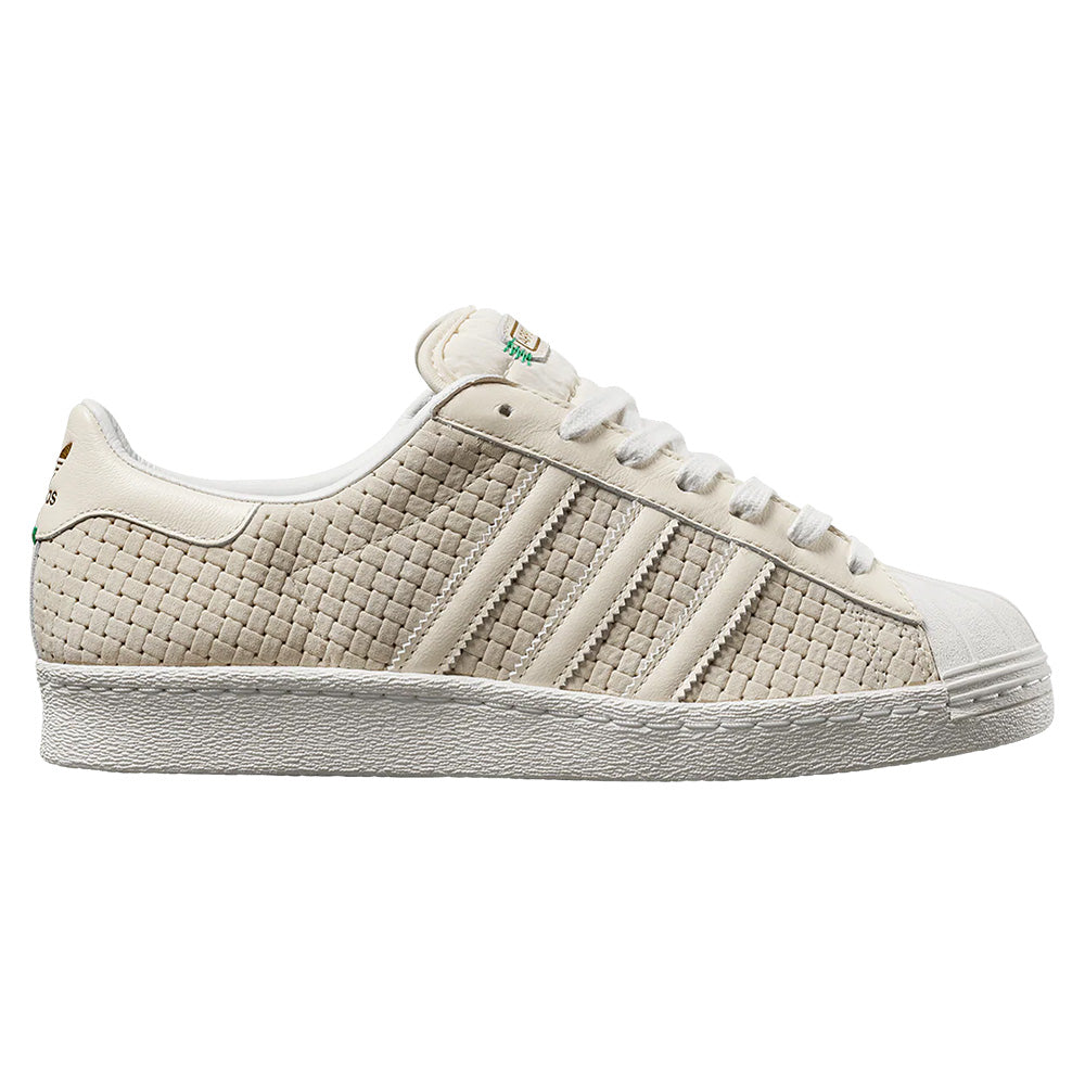 The ADIDAS x ARROW & BEAST SUPERSTAR ADV in Wonder White/Crystal White features a textured woven design, classic three stripes, white laces, and durable cupsole construction for lasting comfort and style.
