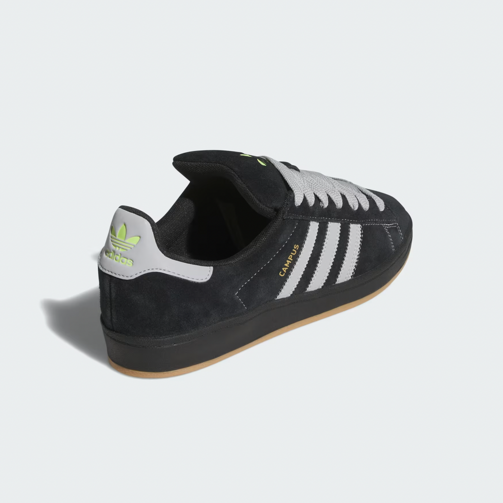 The ADIDAS CAMPUS 90S ADV in Core Black and Grey Two, featuring Gold Metallic accents and a gum sole, is inspired by Henry Jones' classic design. This sneaker elegantly combines timeless style with modern flair, highlighted by subtle branding on the heel.