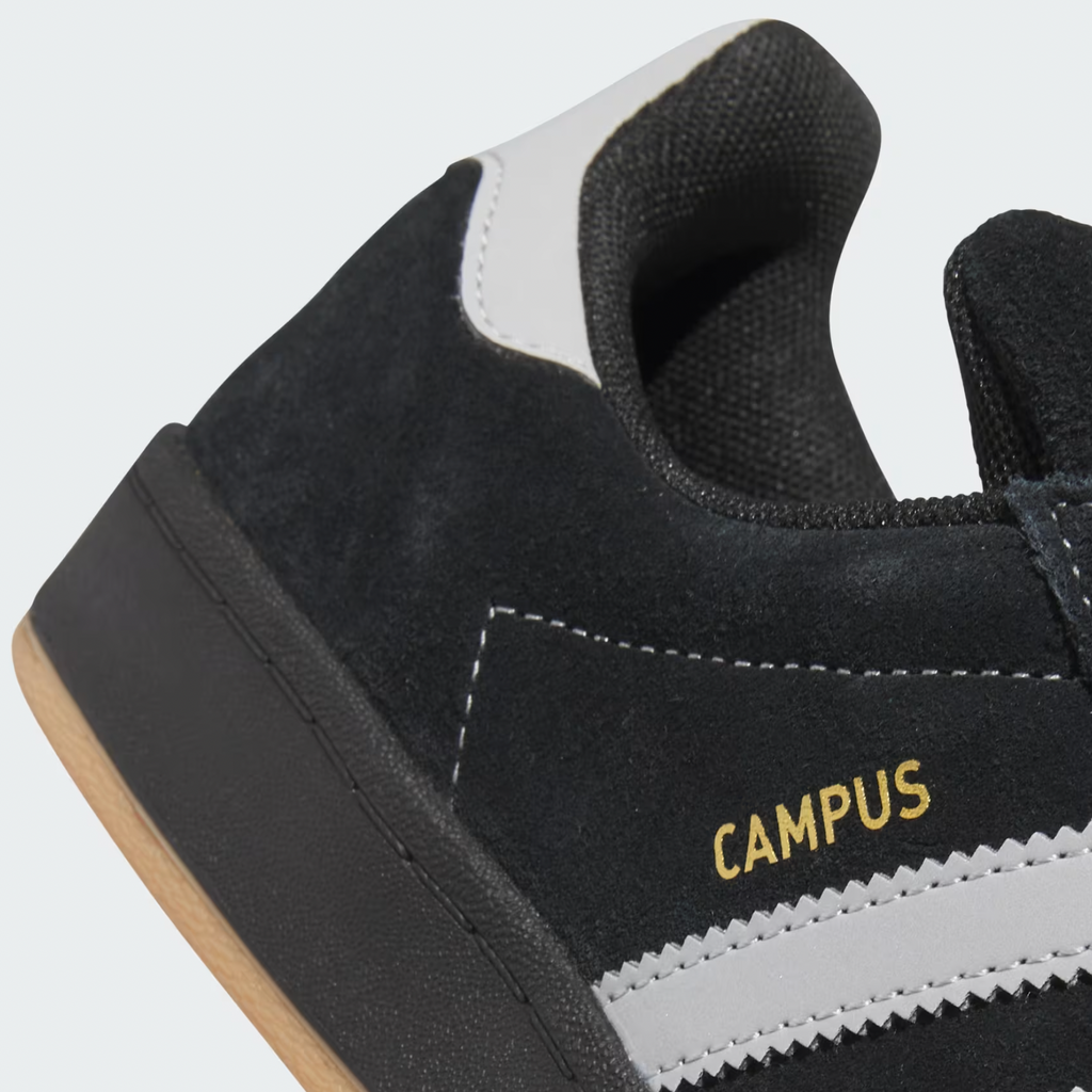 The ADIDAS CAMPUS 90S ADV in Core Black with Grey Two and Gold Metallic details features a black suede body with white accents and the word "CAMPUS" in gold, delivering an elegant, carbon-inspired style akin to something Henry Jones would admire.