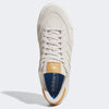 A top view of the ADIDAS NORA ALUMINUM / WHITE / GOLD shoes shows a white sneaker with a tan tongue label, blue insole, and tan heel accent, featuring a modern cupsole design against a plain background.