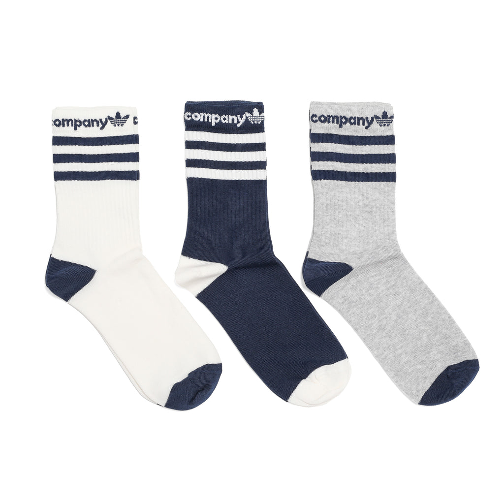 Three pairs of STANCE X POP TRADING CO. crew socks.