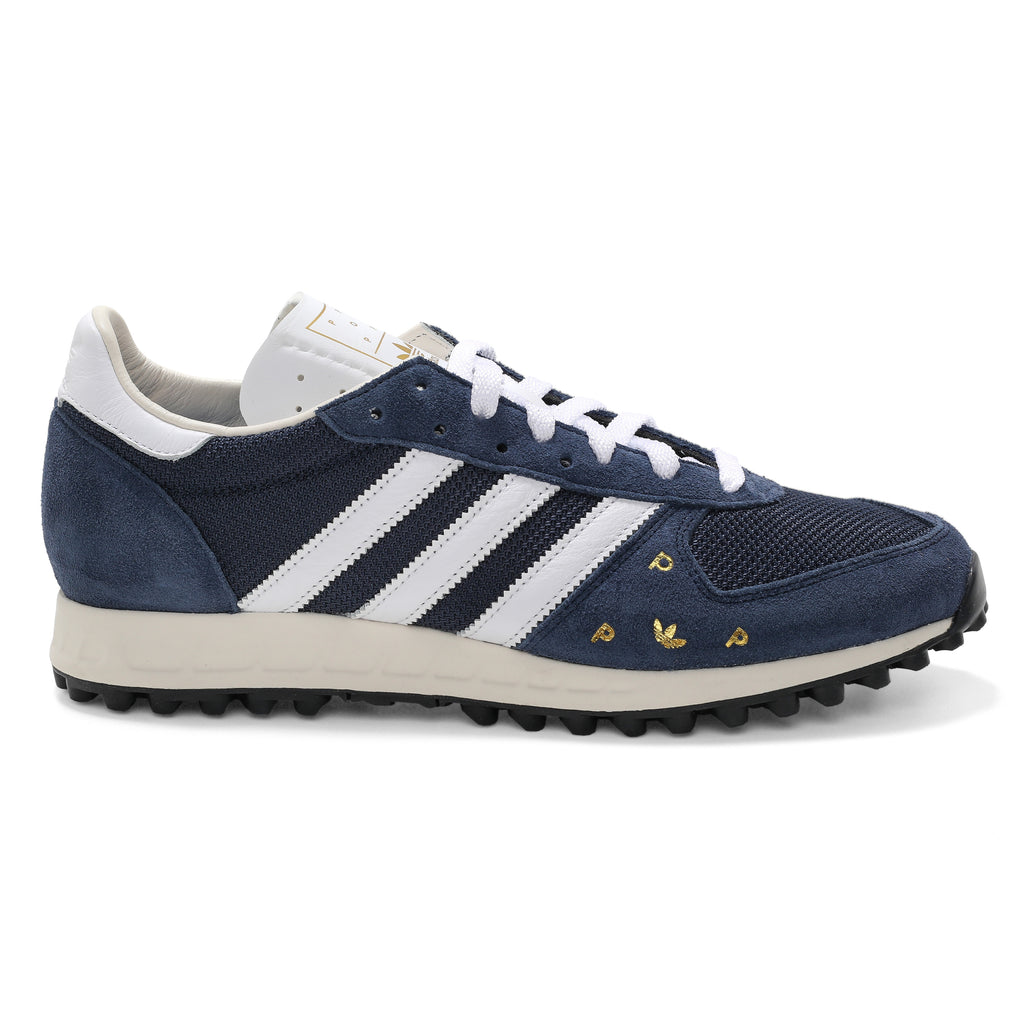 A pair of white ADIDAS X POP TRADING CO. TRX VINTAGE NAVY/WHITE sneakers.