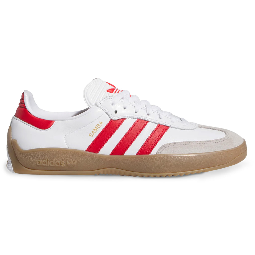 The ADIDAS PUIG SAMBA ADV in Flat White/Better Scarlet/Gum blends skateboarding style with classic design, featuring red stripes, a gum sole, "SAMBA" in gold on the side, and a cushioned EVA midsole for comfort.