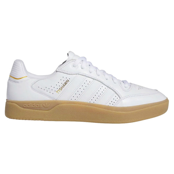 White leather Adidas Skate shoes with small gold letters on the side that say Tyshawn 