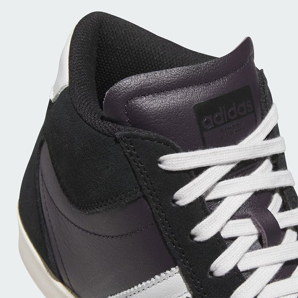 Close-up of the ADIDAS SUPERSKATE ADV in Core Black, Crystal White, and Off White, featuring a suede upper and Adidas logo on the tongue—versatile sneakers ideal for skateboarding.