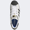 Top view of the ADIDAS SUPERSTAR ADV CRYSTAL WHITE/CORE BLACK sneaker with iconic three black stripes, white laces, and a blue insole showcasing the Adidas logo; features a suede upper and flexible cupsole for enhanced comfort.