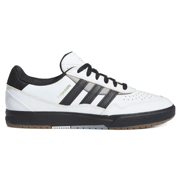 A white and black athletic shoe with three black stripes on the side, branded "ADIDAS TYSHAWN 2 CRYSTAL WHITE / CORE BLACK / CHARCOAL SOLID GREY," featuring a crystal white upper, core black laces, and a textured brown sole.