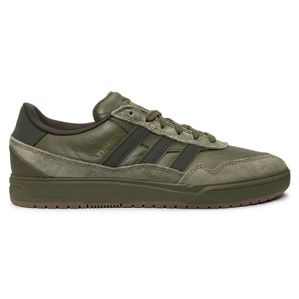 The ADIDAS TYSHAWN 2 OLIVE/GUM is a green suede and leather sneaker with three dark green stripes, a gum rubber sole, and cupsole construction inspired by the original Tyshawn skateboarding shoes.